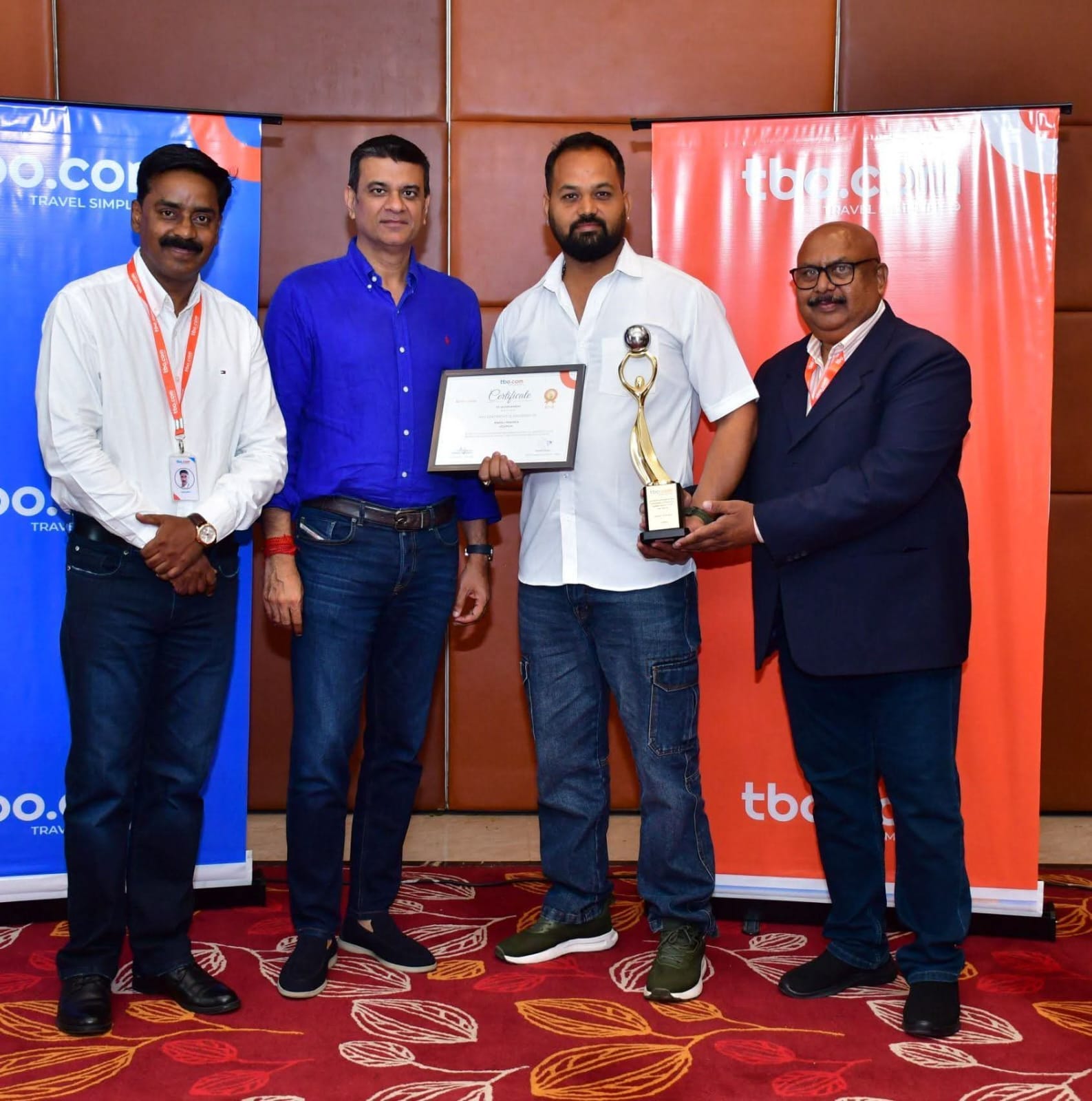 Mr. Pintu Kumar Jhalawat with the TBO.com team, holding the award certificate and trophy
